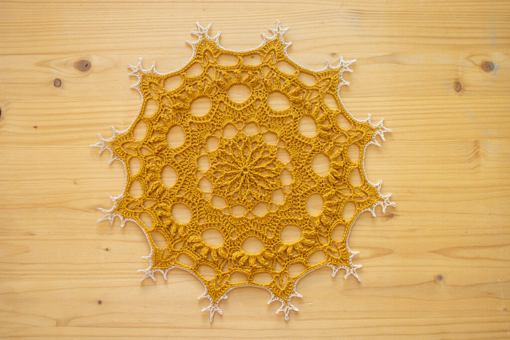 Golden crochet doily, 28 cm