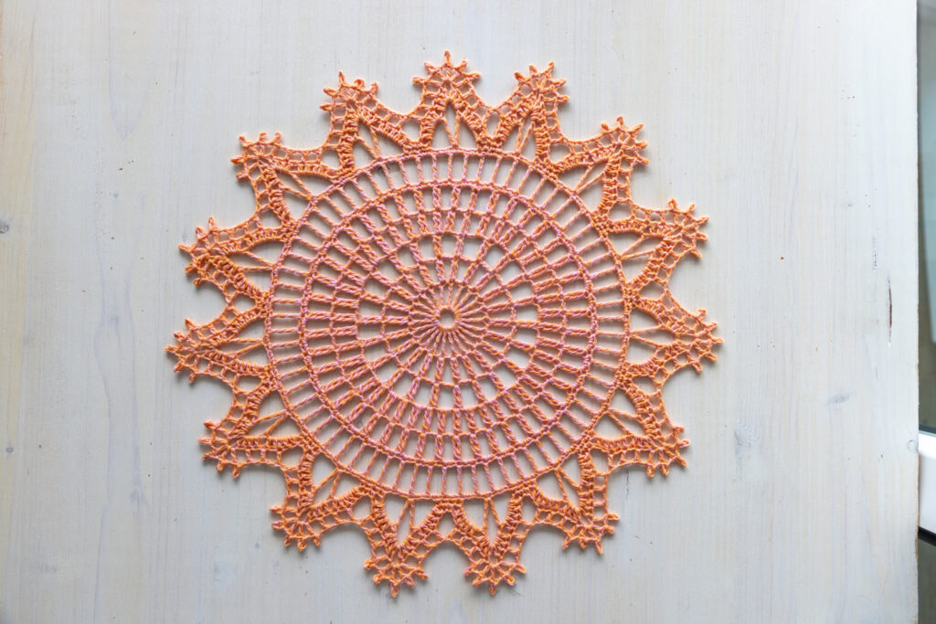 Orange and pink crochet doily, 36 cm